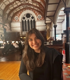 Student smiling in a hall