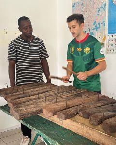 Student playing an instrument while wearing a soccer jersey