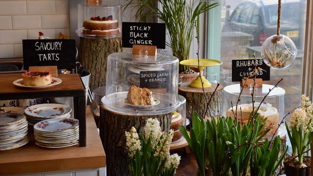 A beautiful display of cakes in a cafe window.