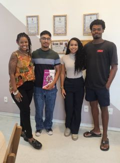 Four people pose for a photo 