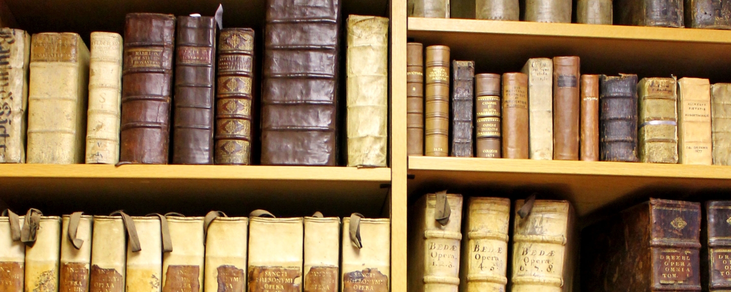 Old books line shelves