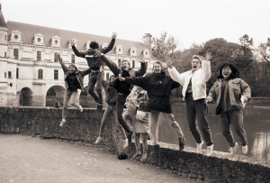Students jumping in front of a chateau