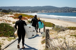 Students heading to the beach with surfboards