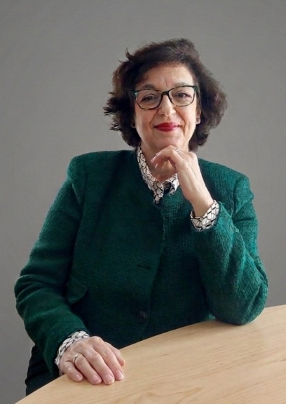 Professor in green with hand on chin