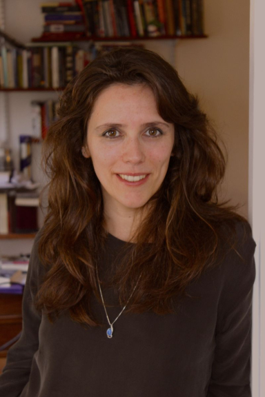 Professor wearing dark sweater and necklace