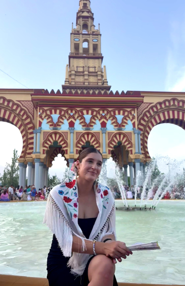 A student sits by a fountain