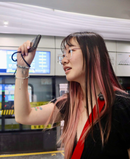 A student holding a phone up to take a photo