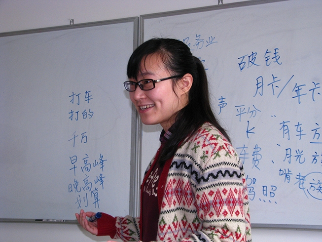Photo of instructor at a white-board at the School in China.