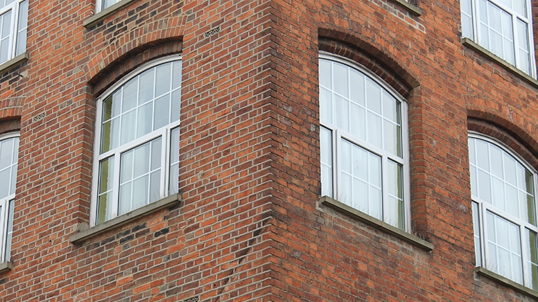 Corner of Saint Michael's Hall showing three upper level windows