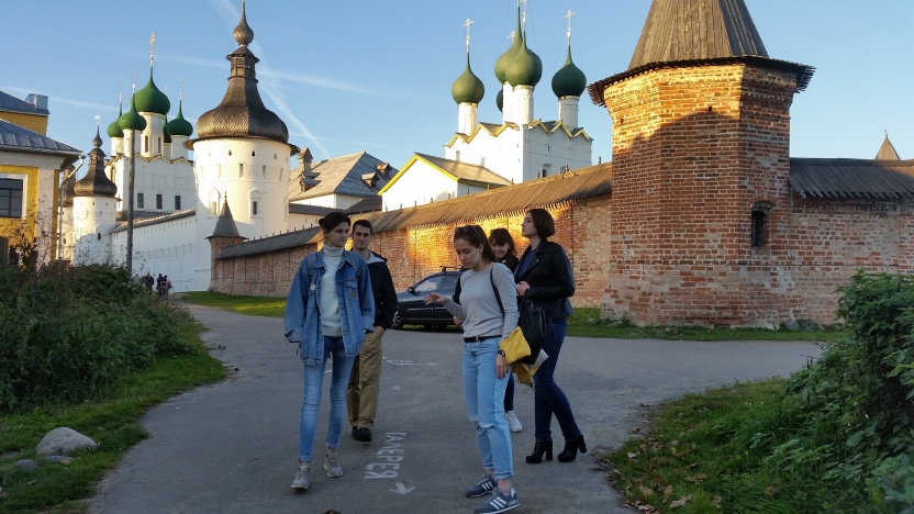 Students and peers walk in a historic area