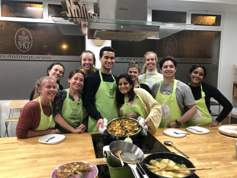 Students showing off the paella they made.