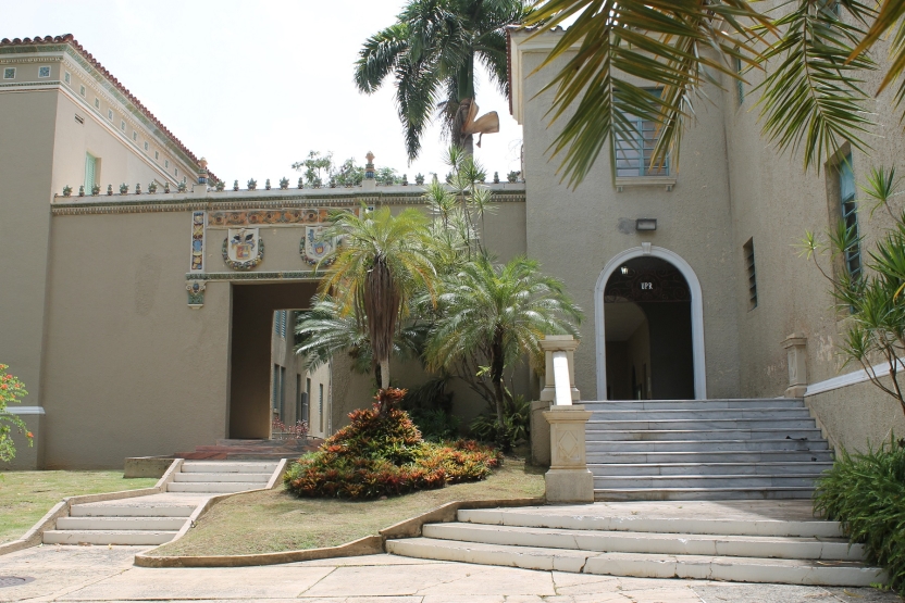 Buildings on campus with a palm tree in front