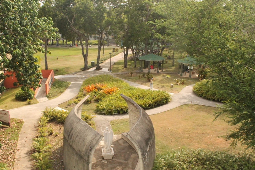 A statue and lawn of campus as seen from above