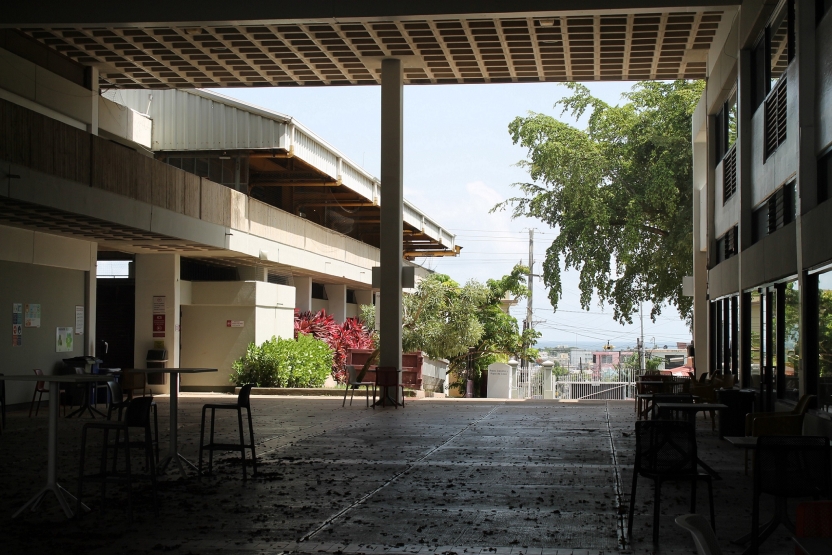 A view through a campus walkway looking over a neighborhood