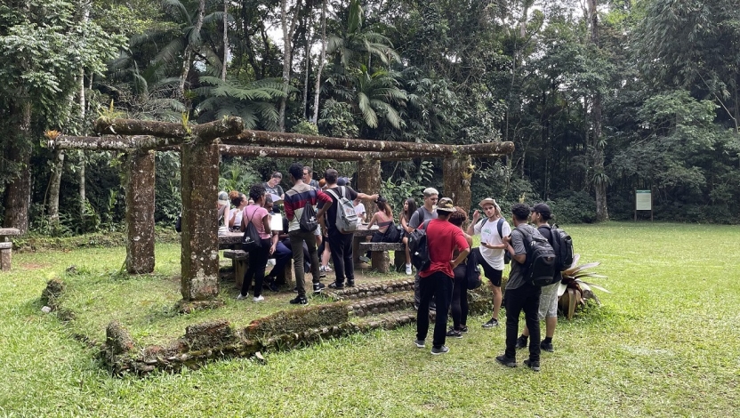 Students in a national park gathering under a pavilion 