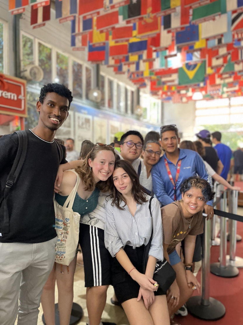 Students under assorted national flags from around the world