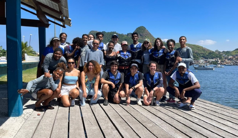 Students posing together on a dock