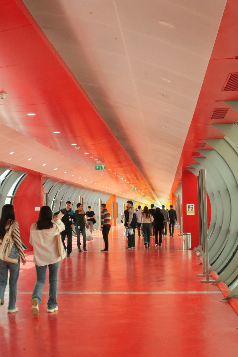 Students walking down a long corridor