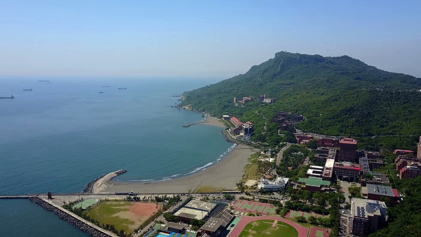 The view of campus from above, positioned between a mountain and a shoreline