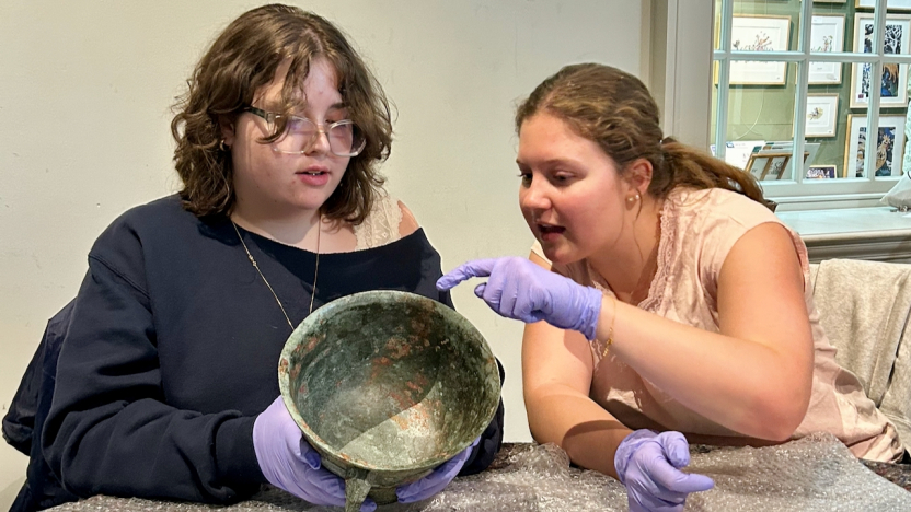 Two students handle a historic artefact at Compton Verney.