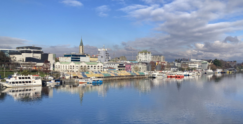 Colorful boats and buildings along a river