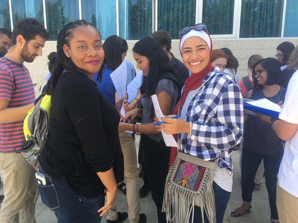 Students talk together outside a university building