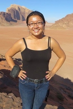 A student smiling in the desert
