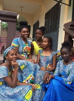 A student with her host sister and friends, wearing matching dresses