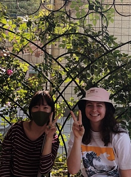 A student and her Chinese roommate give the peace sign