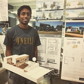 A student with his architecture project in a classroom