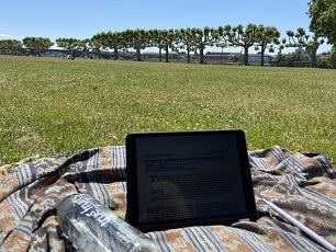 A tablet on a blanket set up outside