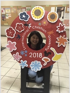 Wellesley student at the Middlebury School in Japan poses at the host university International Christian University
