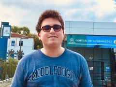 A student in a Middlebury shirt smiling
