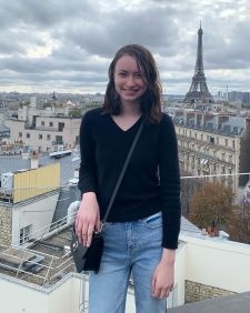 Student smiling with the Eiffel tower in the background