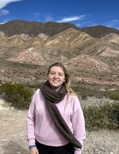 Student smiling with dry mountains in the background