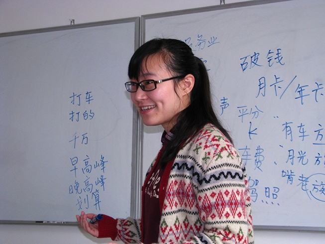 Photo of instructor at a white-board at the School in China.