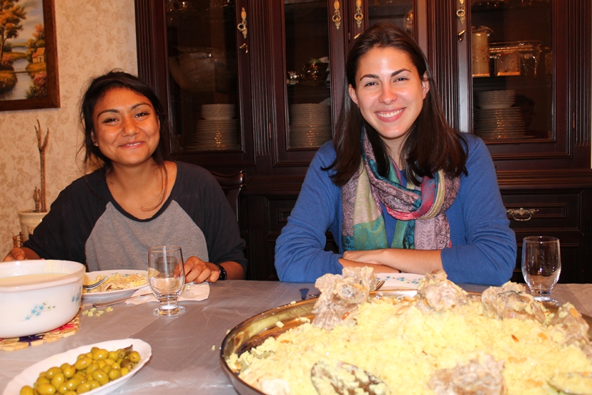 Photo of two female students at the dinner table at their homestay in Amman.