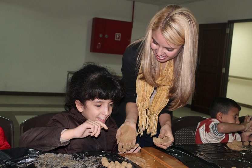 Photo of a student playing with a Jordanian child at the Academy for the Blind, in Amman.