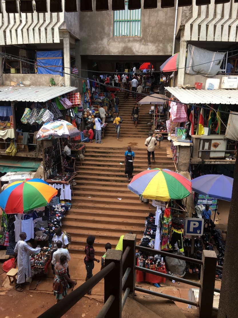 The entrance to a market building, with vendors set up outside