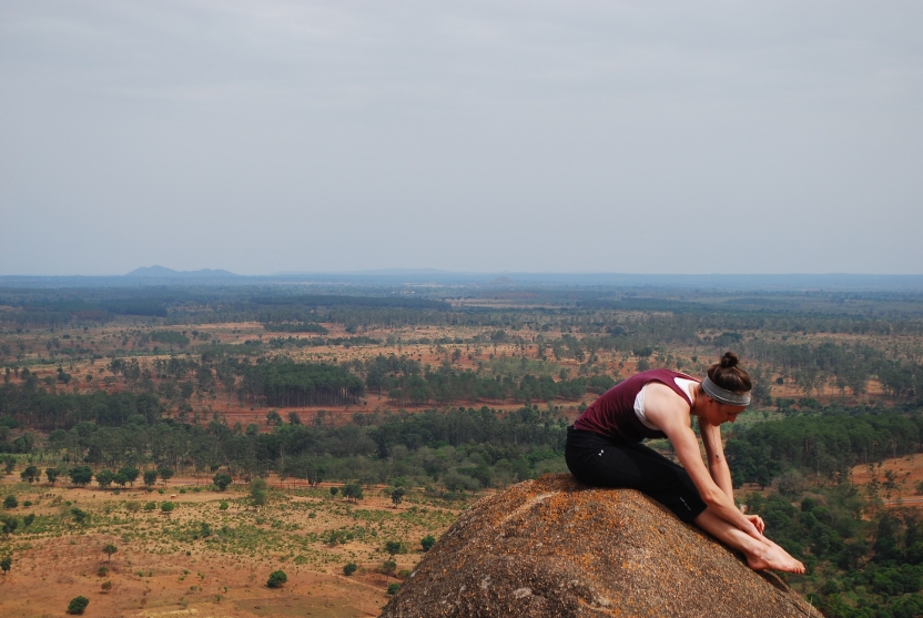A student stretches on a mountain