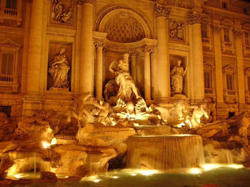 Sculptures around the Trevi Fountain lit up at night