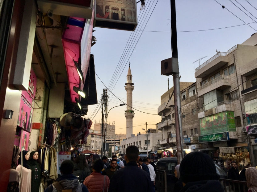 A busy street with a mosque in the background