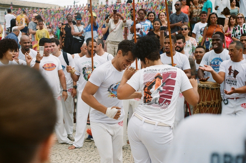 People playing capoeira with a crowd around them