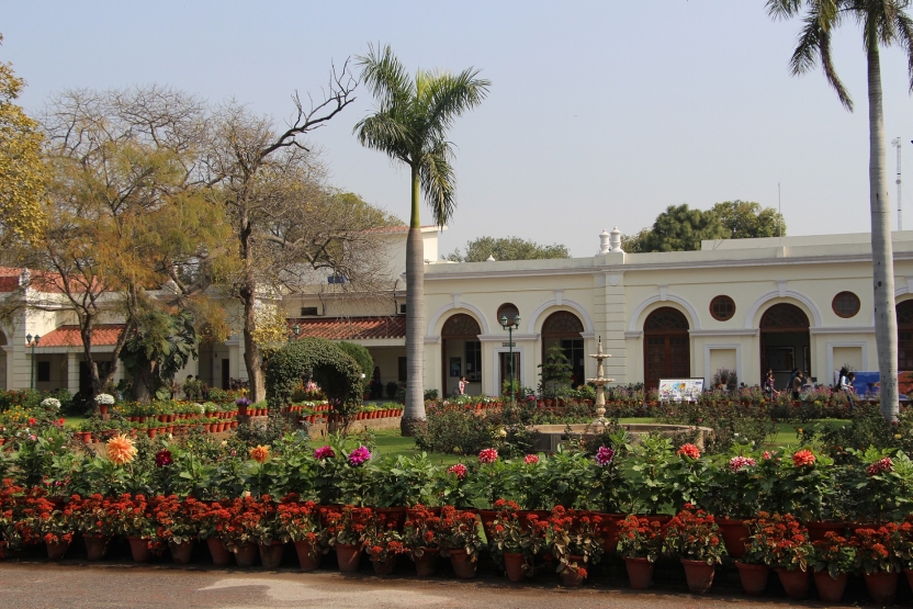 A white building with gardens surrounding it
