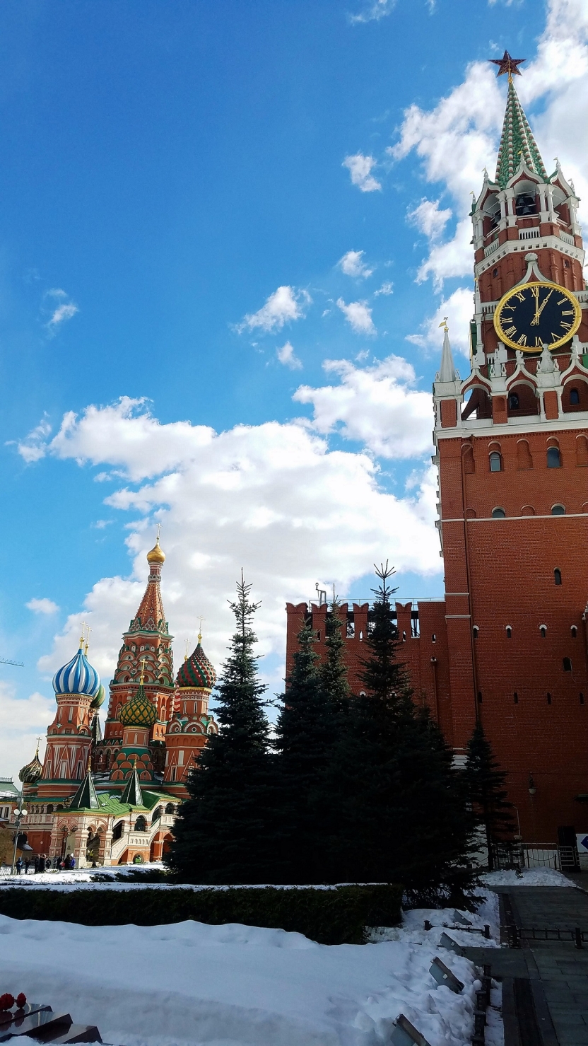 A tower in the forefront, with a cathedral in the background