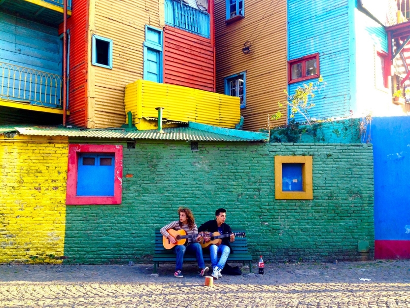 Two boys playing guitars in the La Boca neighborhood of Buenos Aires