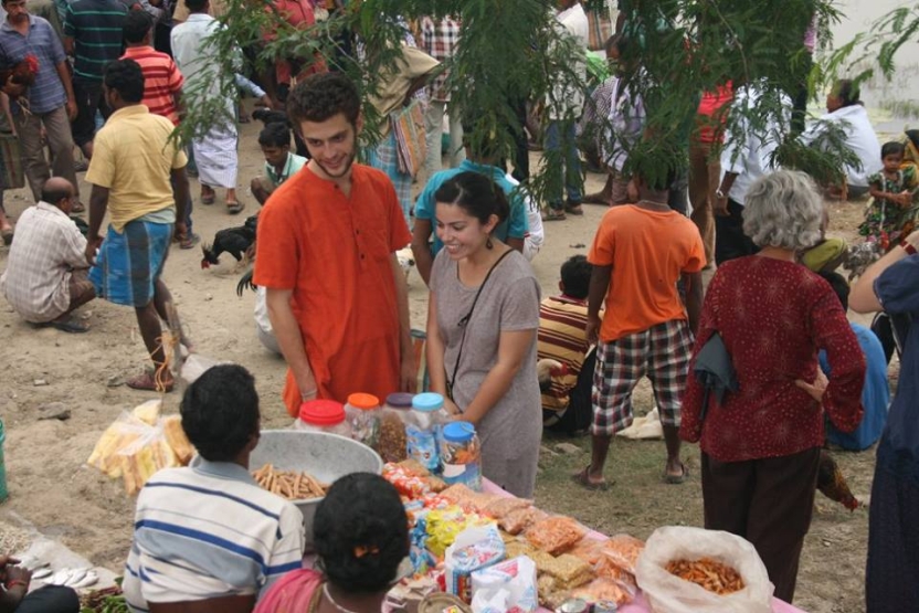 Students speak to a vendor on the street