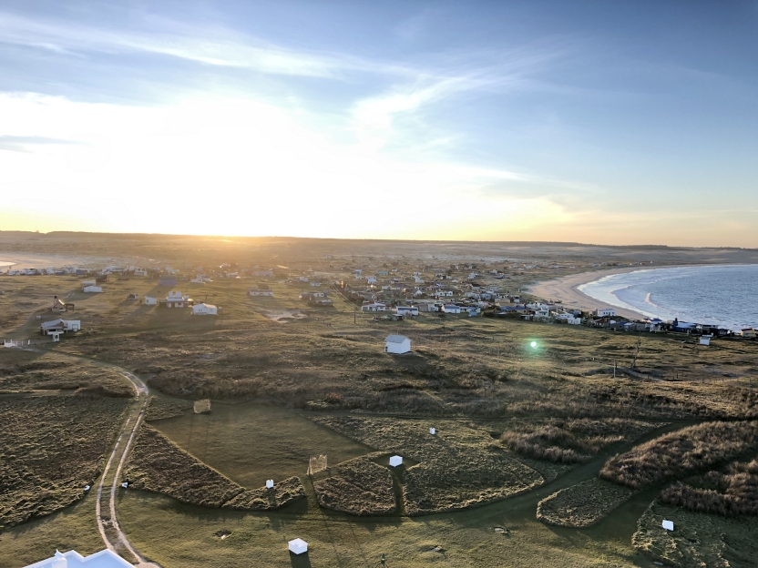 sunset over a small rural town near a body of water