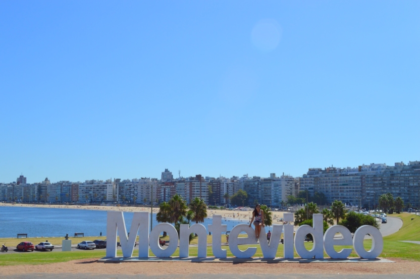 A student sits on a giant string of letters that spell out "Montevideo"