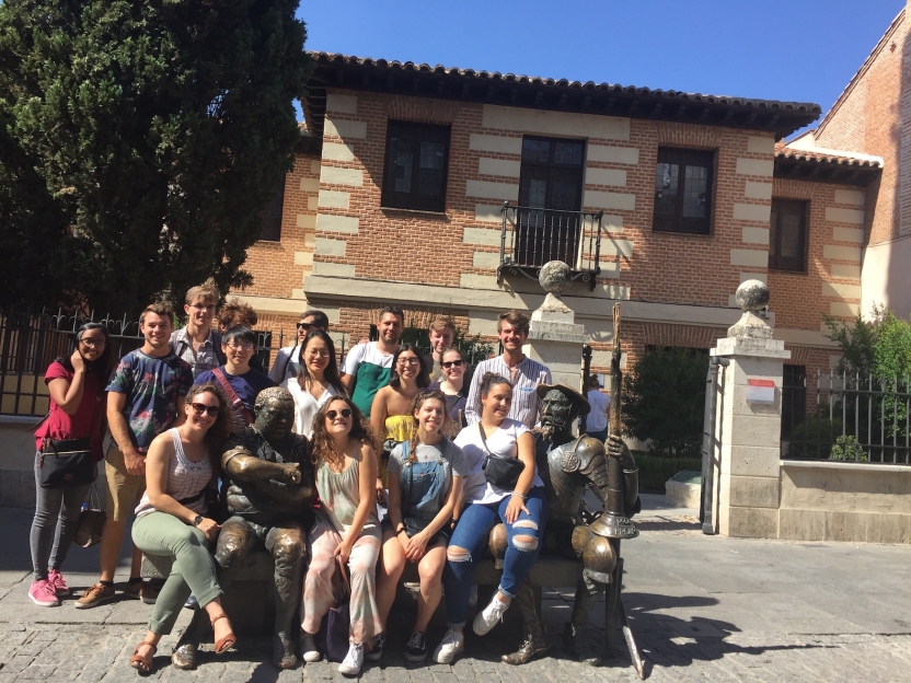 Students sitting with the Don Quijote statue in front of the museum of the house were Cervantes was born.